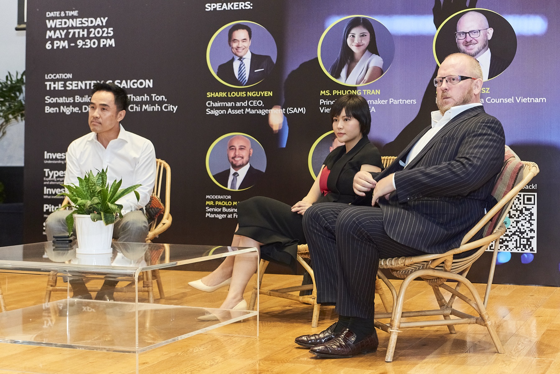 Speakers on stage at an investment panel